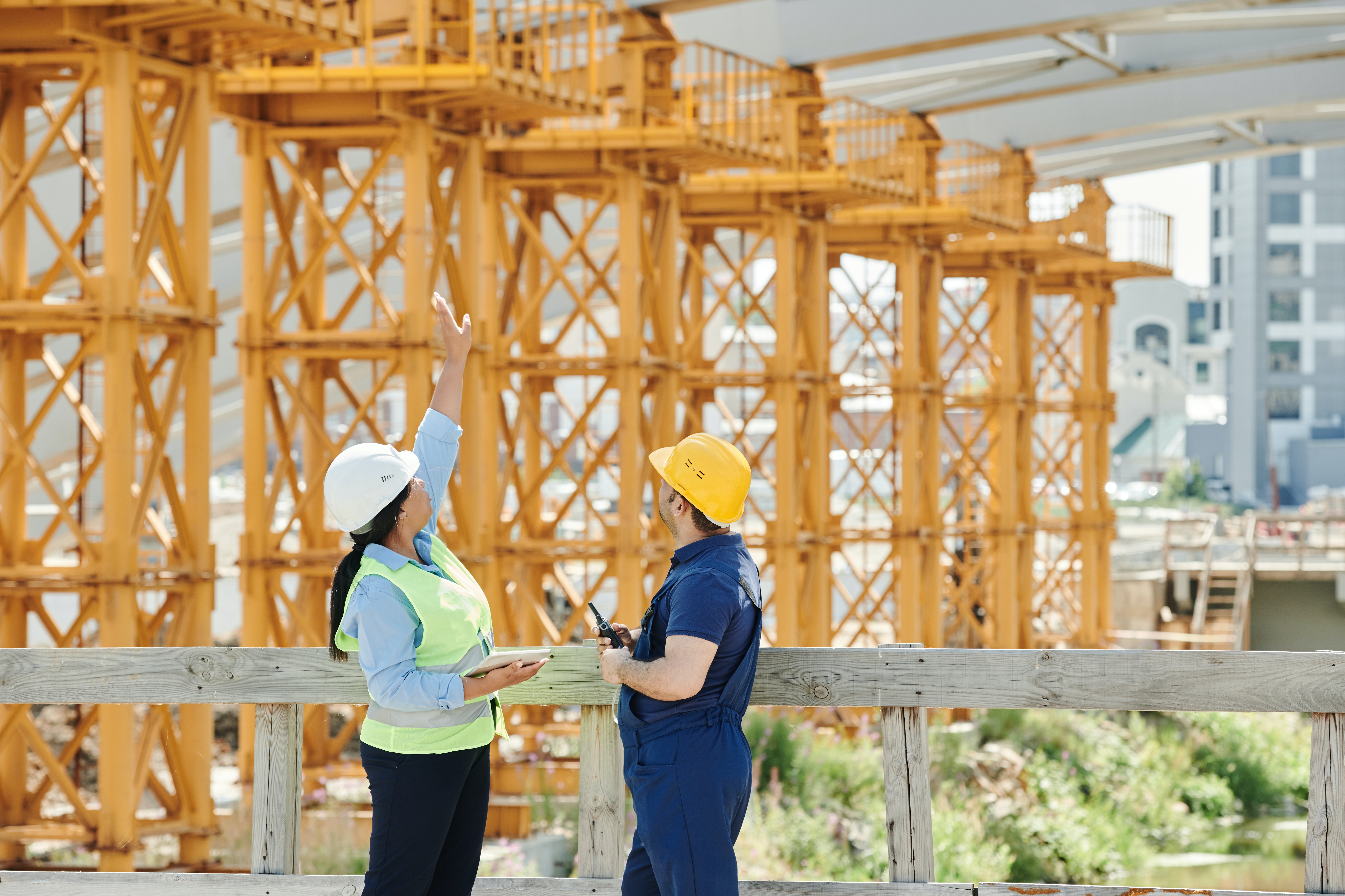Construction workers standing on a job site discussing inspection details
